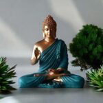 Meditating Buddha statue for home decor placed on a wooden table